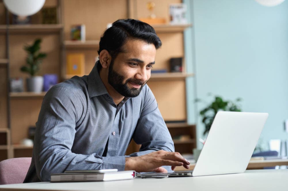 An agent working through KW Southwest online training on a laptop